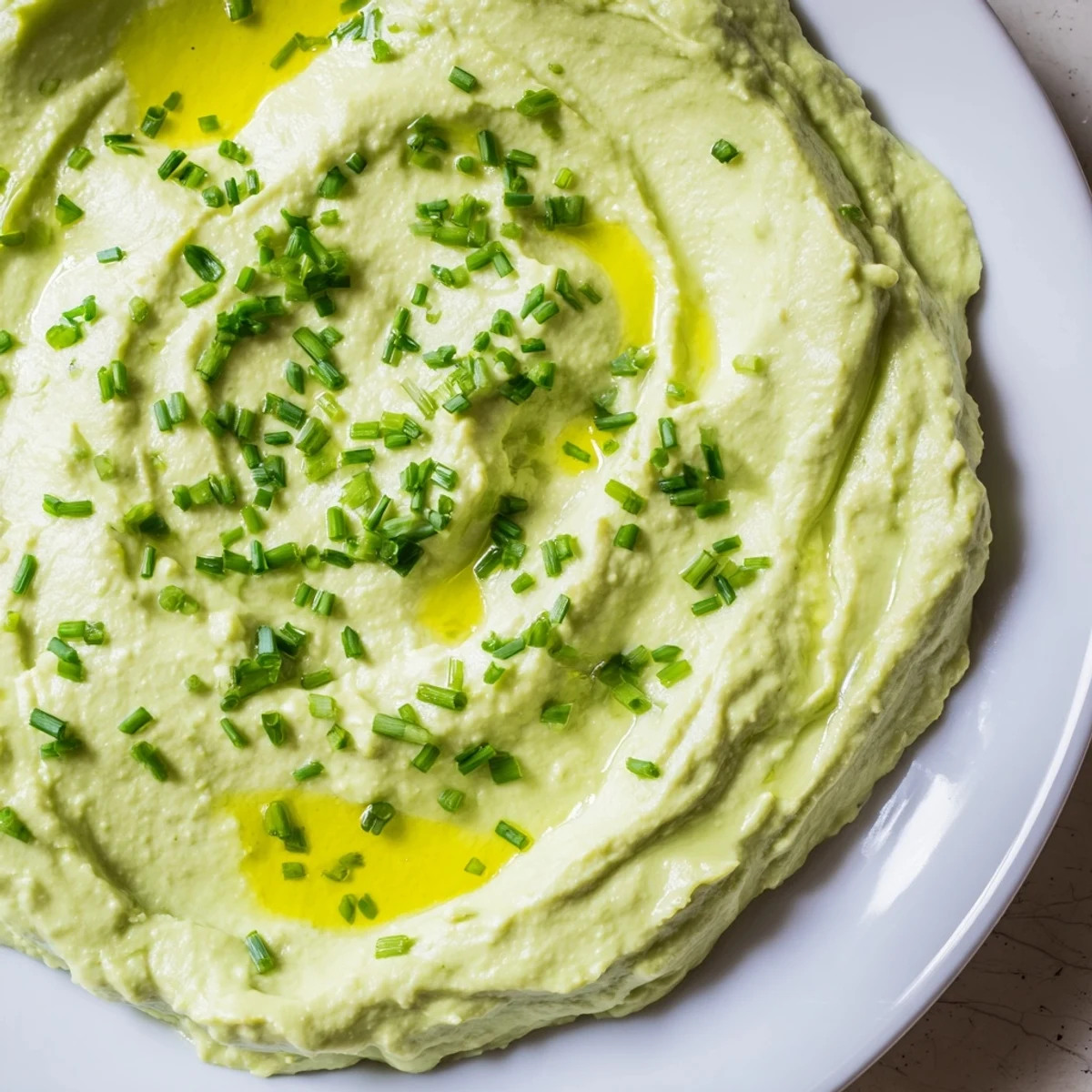 Creamy avocado cottage cheese dip, a vibrant green, ready to be served with crunchy vegetables.