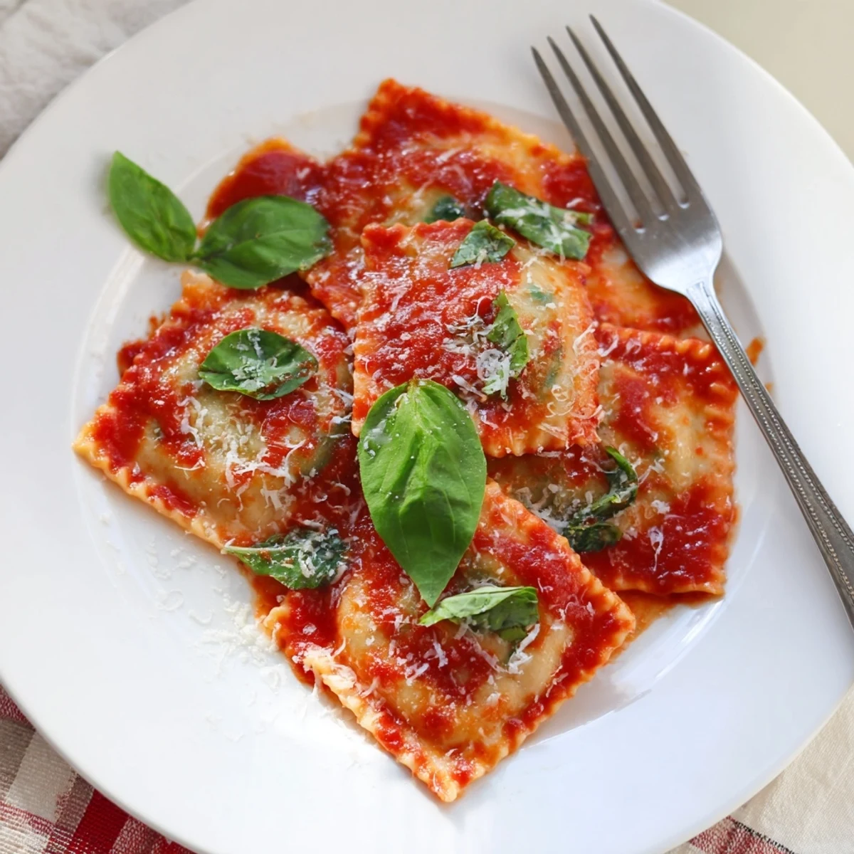 Steaming ravioli with ricotta and spinach, ready to be served with extra Parmesan.  