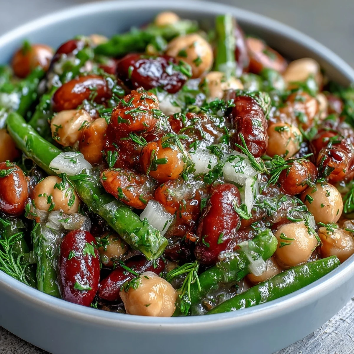 Fresh Three-Bean Salad with chickpeas, kidney beans, and crisp green beans tossed in a tangy apple cider vinaigrette.  