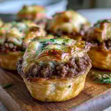 Freshly baked Mini Beef Tourtières arranged on a serving platter, ready to be dipped into tangy Dijon mustard. 