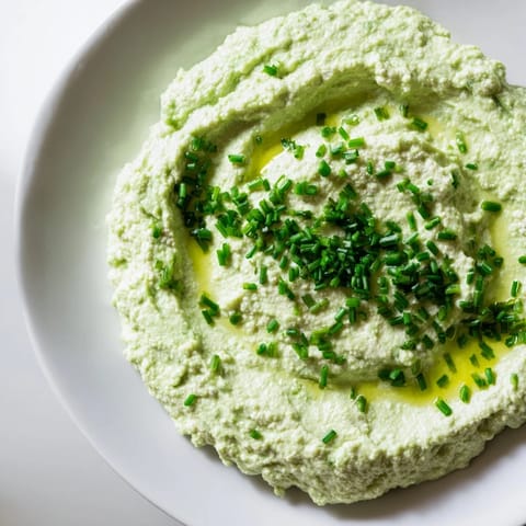 A smooth and flavorful avocado cottage cheese dip, perfect for spreading on crackers or toast, ready now.