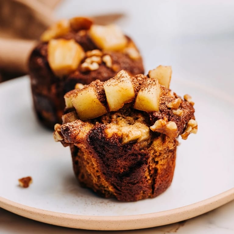 A delightful platter of warm Seasonal Spiced Pear and Walnut Muffins, perfect for a weekend breakfast.