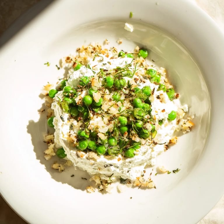 Close-up of Creamy Parmesan Orzo with Green Peas, showing cooked orzo and melted Parmesan, ready to eat.