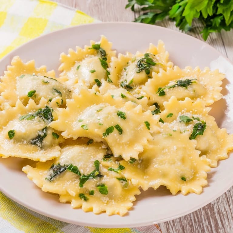 A close-up of baked Savory Spinach and Ricotta Puff Pastry Triangles, showcasing a warm, cheesy filling.