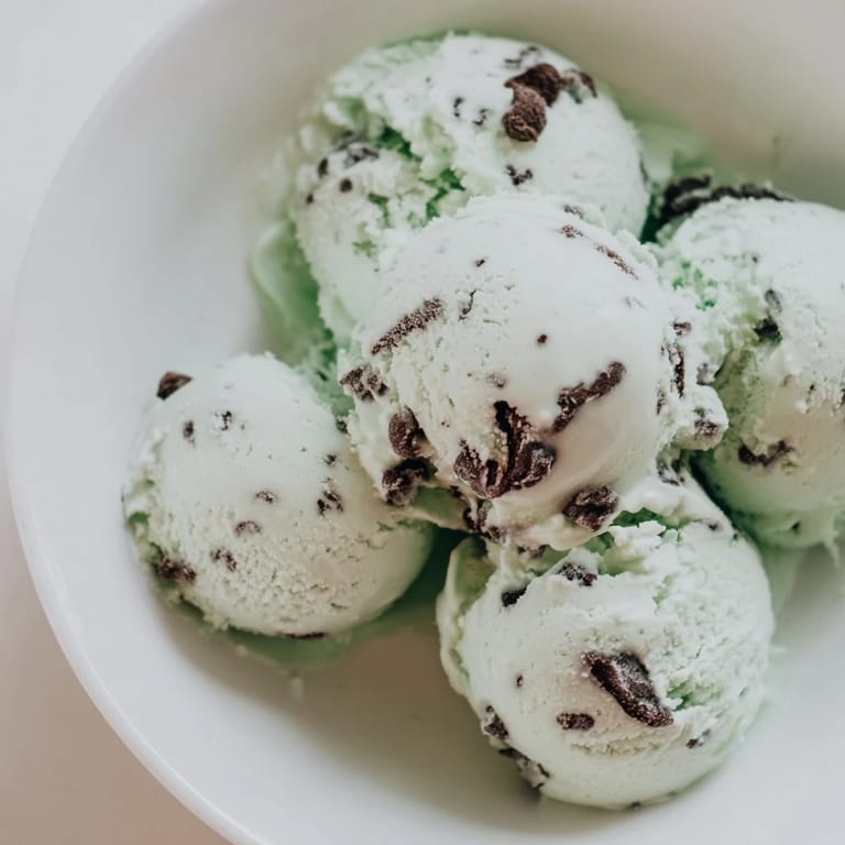 A generous scoop of refreshing Mint Chocolate Chip Ice Cream, perfect for a summer dessert, captured.