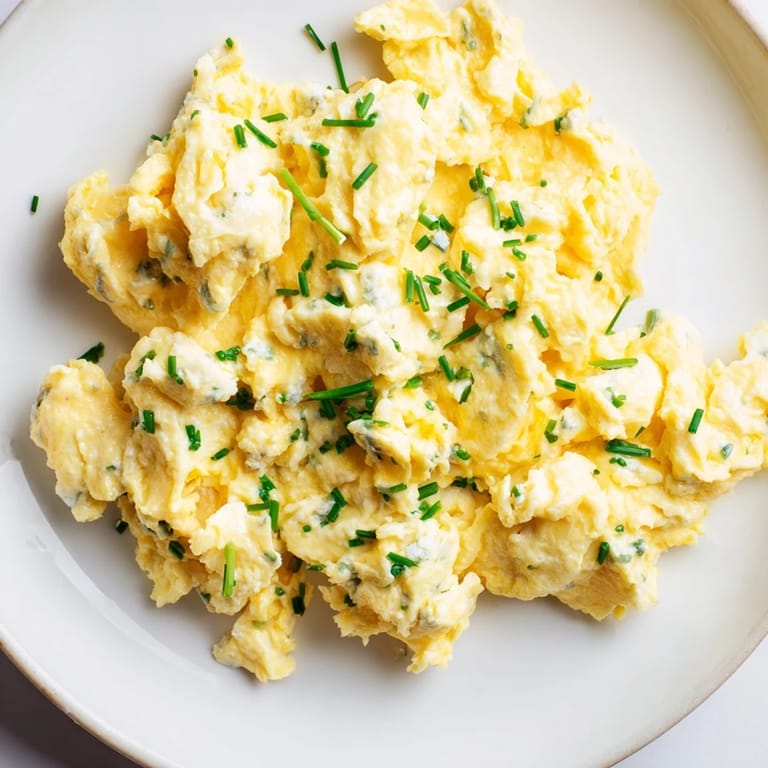 A plate of light and airy Cottage Cheese Scrambled Eggs, a delicious and easy American breakfast.