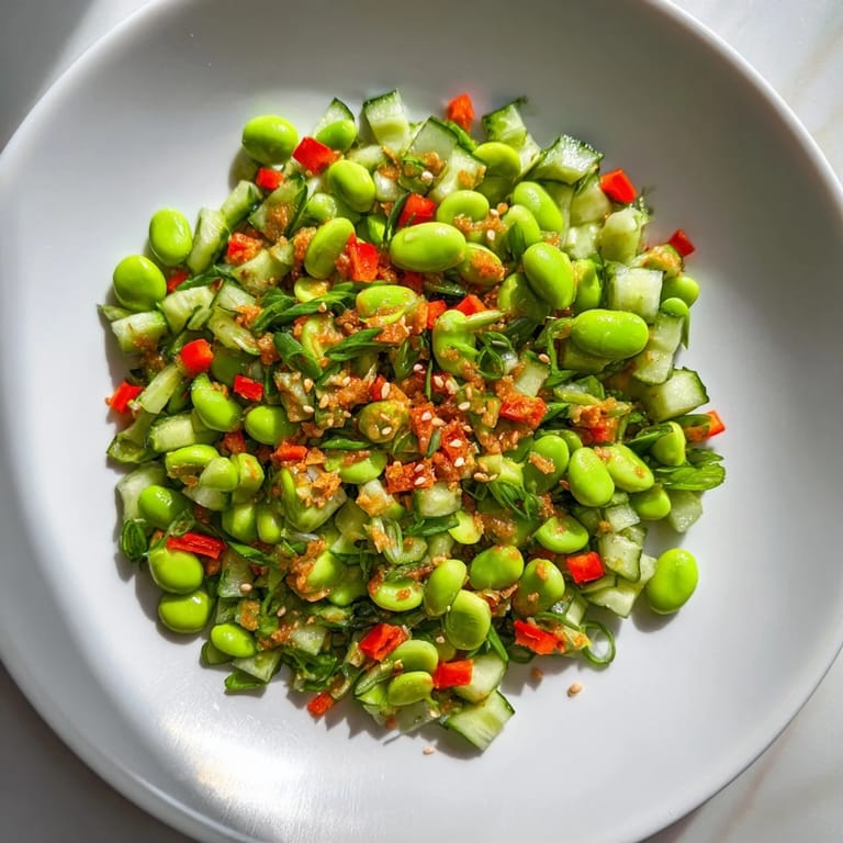 A beautiful bowl of Edamame Salad loaded with fresh vegetables and sesame seeds.