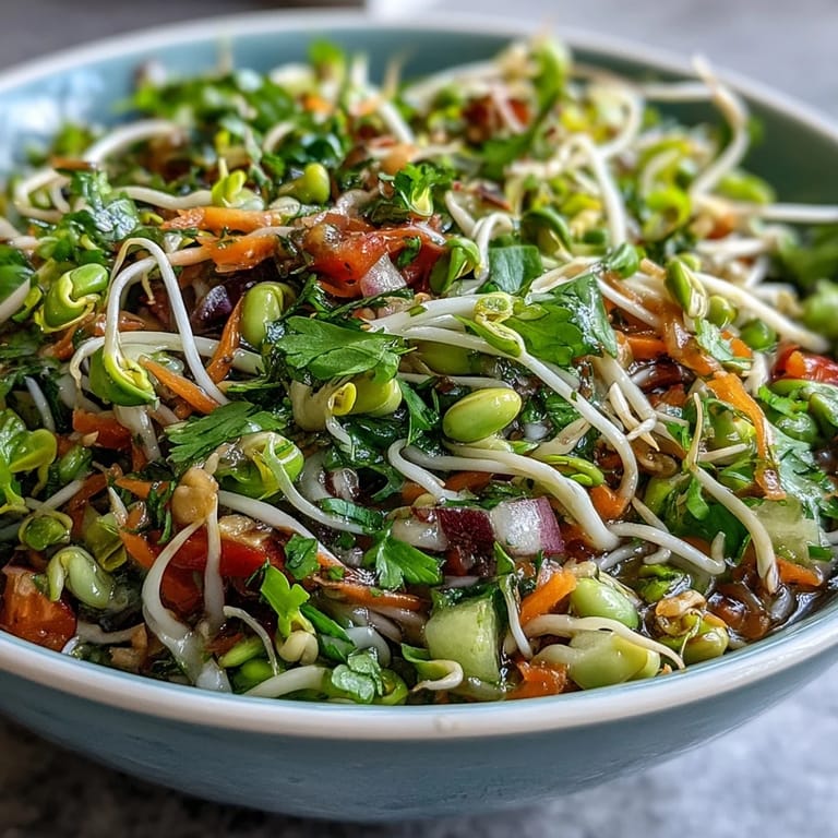 Refreshing Sprouted Seed Salad bowl with diced tomatoes, grated carrots, and red onion, perfect for a quick, gluten-free lunch.