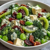 Vibrant green snack board with fruits, veggies, cheeses, and treats perfect for St. Patrick's Day celebrations.  